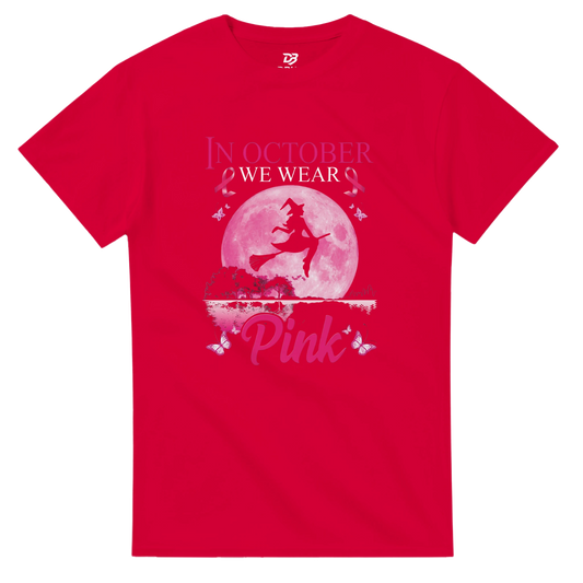 Red unisex T-shirt with pink witch-on-broom moon graphic and “Pink” ribbon text