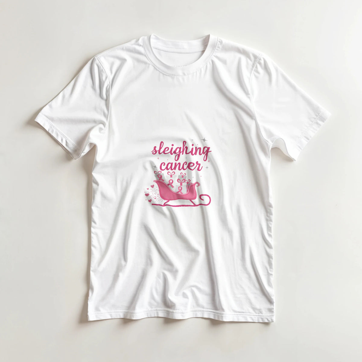 White crewneck cancer support T-shirt with pink “sleighing cancer” sleigh graphic