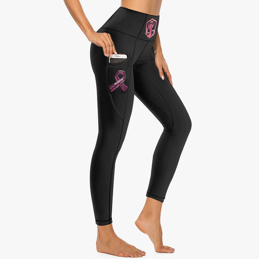 High-rise black leggings with pink ribbon patch on side pocket and stitched logo at hip