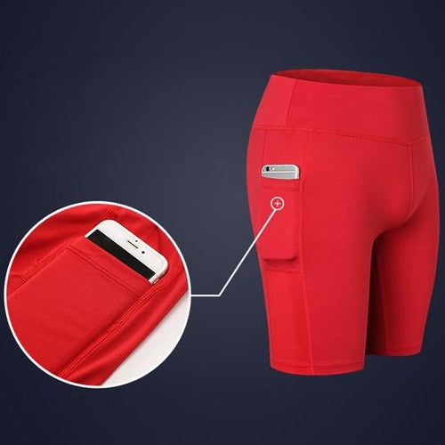 Red yoga shorts with phone pocket, with inset showing phone in pocket.