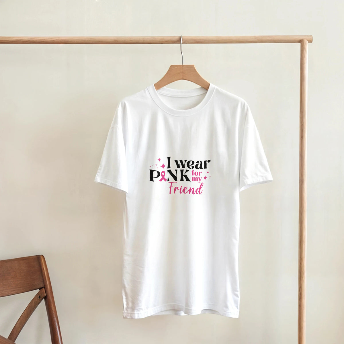White unisex T-shirt with “I wear Pink for my Friend” breast cancer awareness graphic