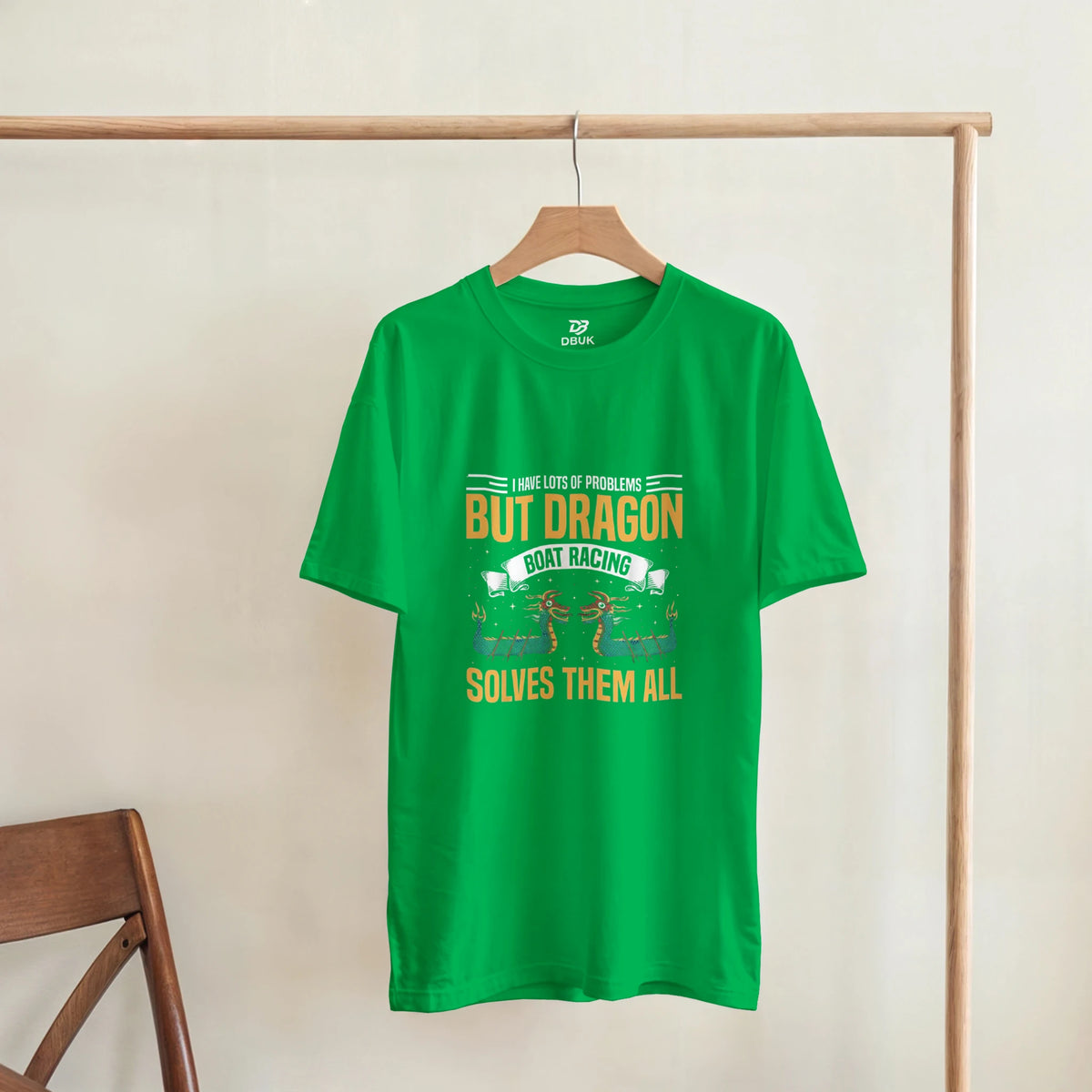Green unisex graphic T-shirt displayed on a hanger; dragon boat racing text
