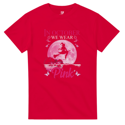 Red unisex T-shirt with pink witch-on-broom moon graphic and “Pink” ribbon text