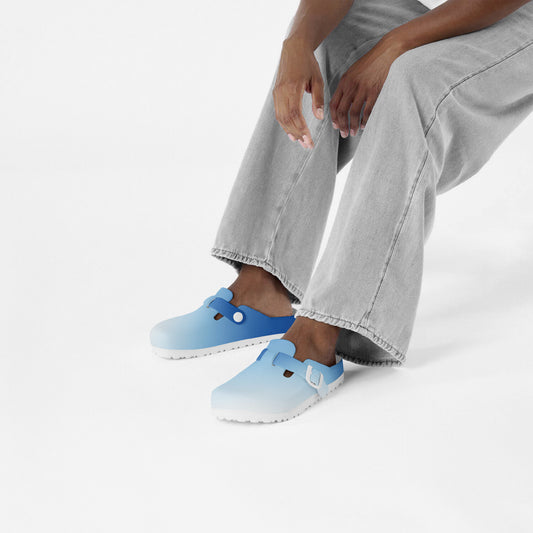 Light blue EVA slip-on clogs on feet with short jeans and socks