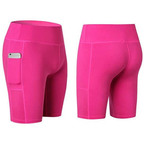 Pink yoga shorts with phone pocket detail, stretch fabric, mid-thigh length