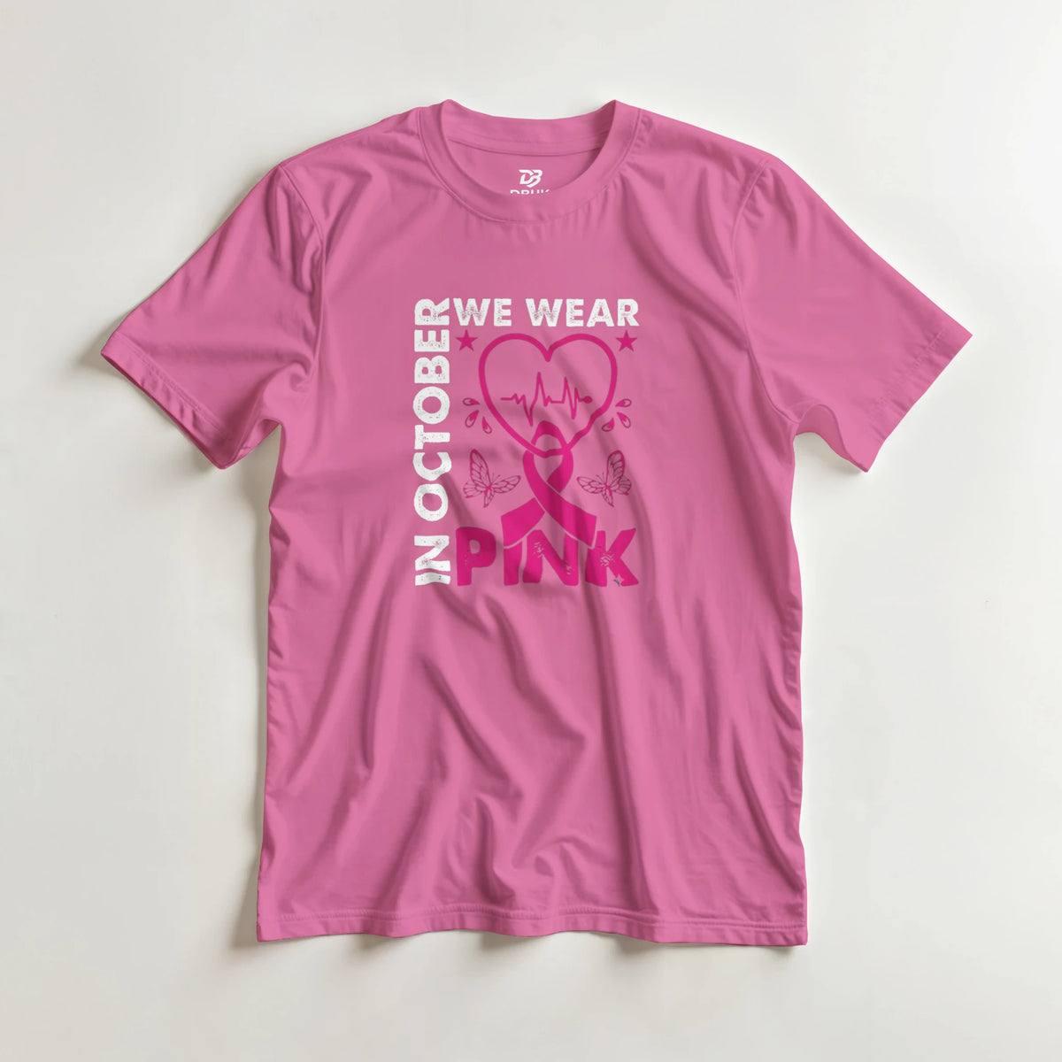 Pink unisex T-shirt with 'OCTOBER WE WEAR PINK' heart ribbon graphic