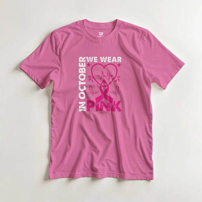 Pink unisex T-shirt with 'OCTOBER WE WEAR PINK' heart ribbon graphic