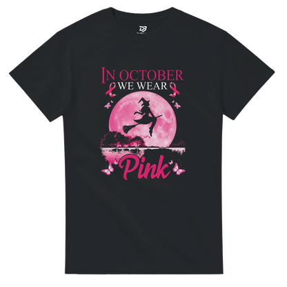 Black unisex T-shirt with pink witch-on-broom moon graphic and “Pink” ribbon text
