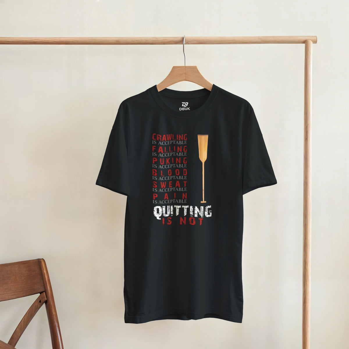 Black unisex graphic tee with centered trophy and stacked quote typography