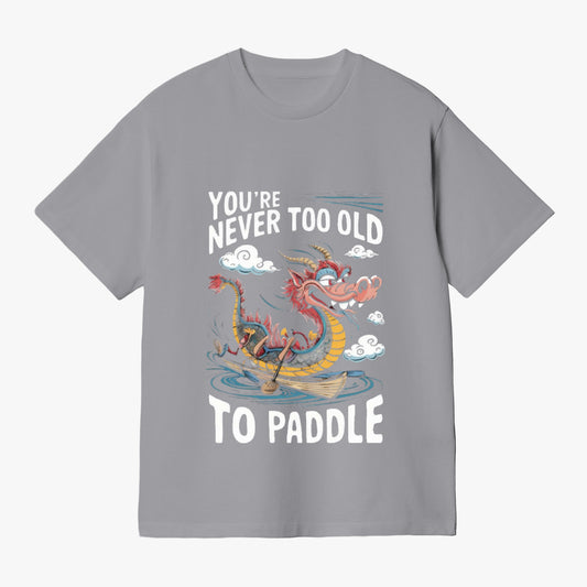 Unisex light gray tee with "You're Never Too Old" "To Paddle" sea monster graphic