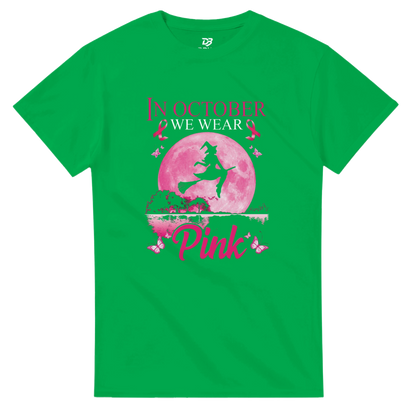 Green unisex T-shirt with pink witch-on-broom moon graphic and “Pink” ribbon text