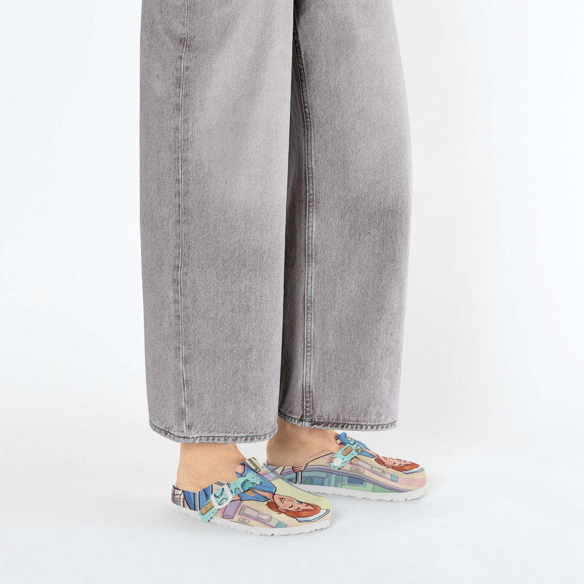 Nurse clog side view, right outside, featuring light blue/cream cartoon nursing print and outsole.