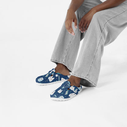 Dental print slip-on clogs on feet, blue EVA shoes with dental-themed cartoon pattern.