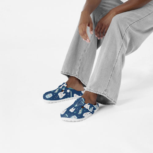 Dental print slip-on clogs on feet, blue EVA shoes with dental-themed cartoon pattern.