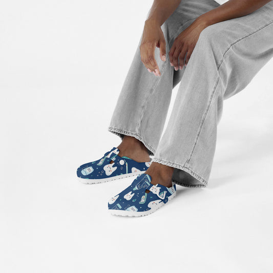 Dental print slip-on clogs on feet, blue EVA shoes with dental-themed cartoon pattern.