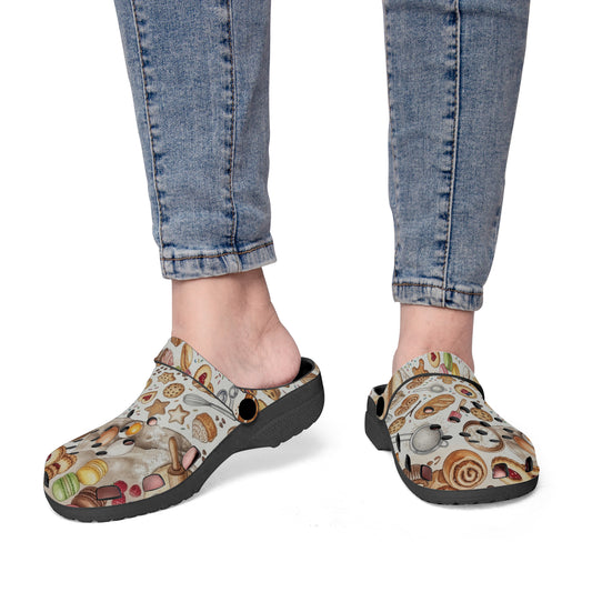 Kitchen clogs on feet with beige food pattern uppers and dark rubber outsole, slip-on.