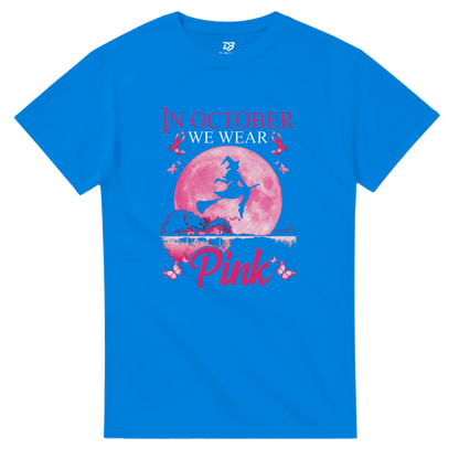 Blue unisex T-shirt with pink witch-on-broom moon graphic and “Pink” ribbon text