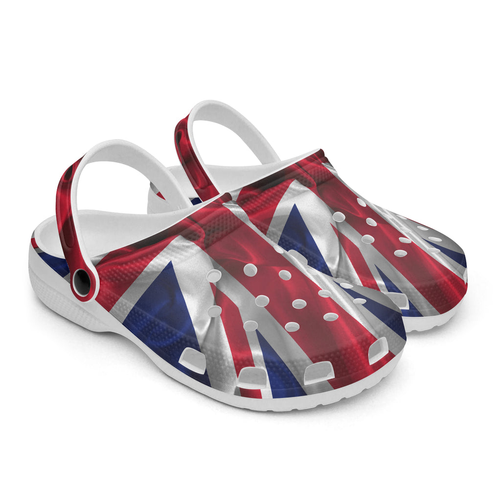 A pair of white clogs with a printed Union Jack flag design on the uppers, shown on a clean white background.