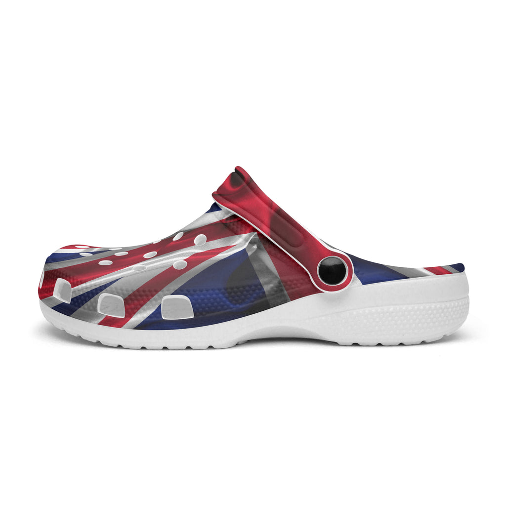 A single clog-style shoe with a Union Jack flag print in red, white, and blue, featuring a white textured sole, shown from a side profile on a white background.
