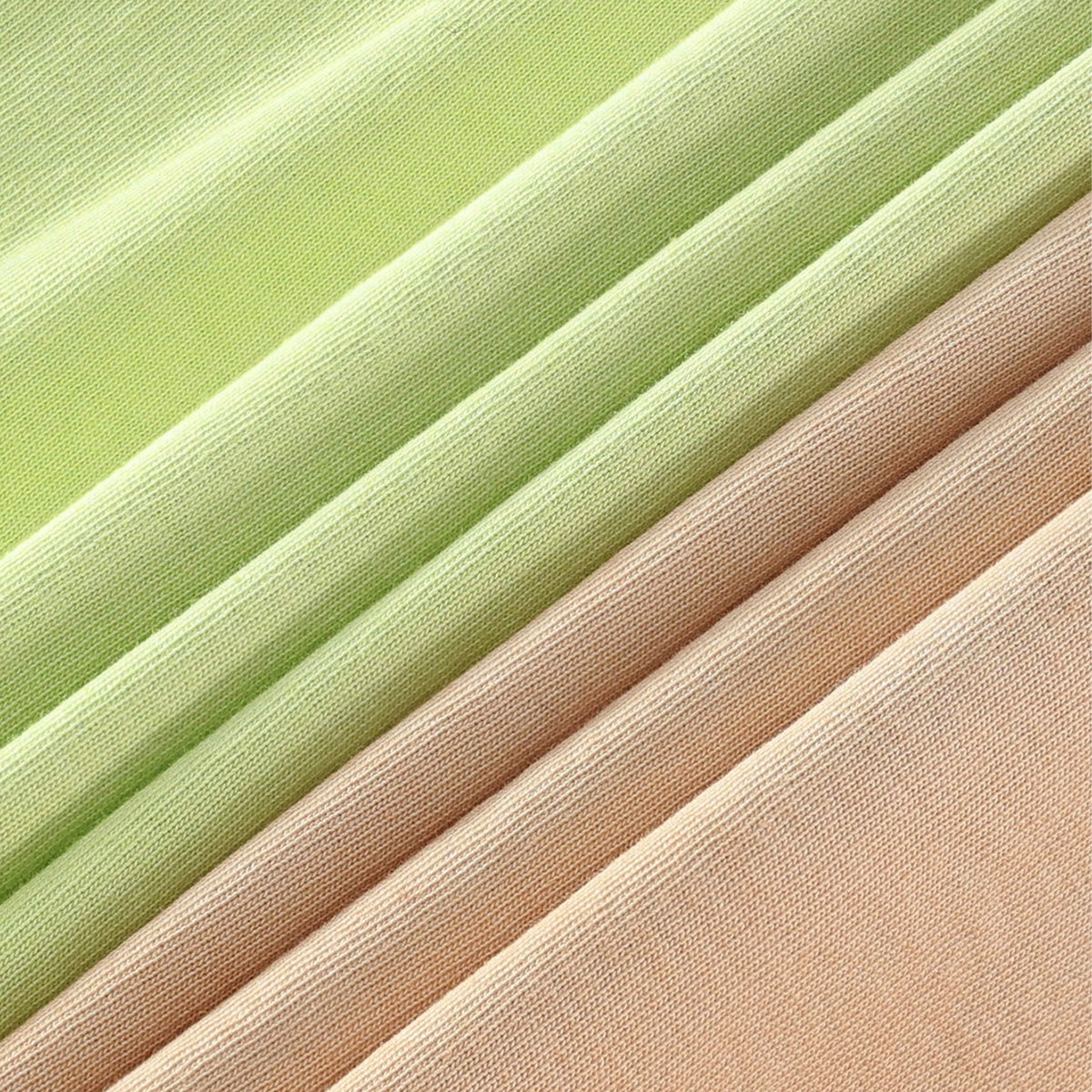 Washed cotton fabric swatches in lime green and tan, close-up