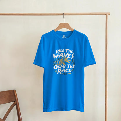 Unisex blue T-shirt with “Ride the Waves / Own the Race” dragon graphic, hanging
