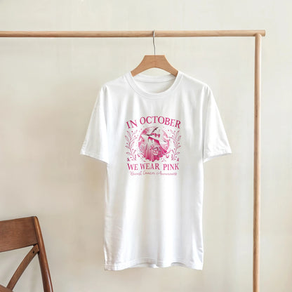 White crewneck unisex T-shirt on a hanger with pink awareness floral wreath graphic