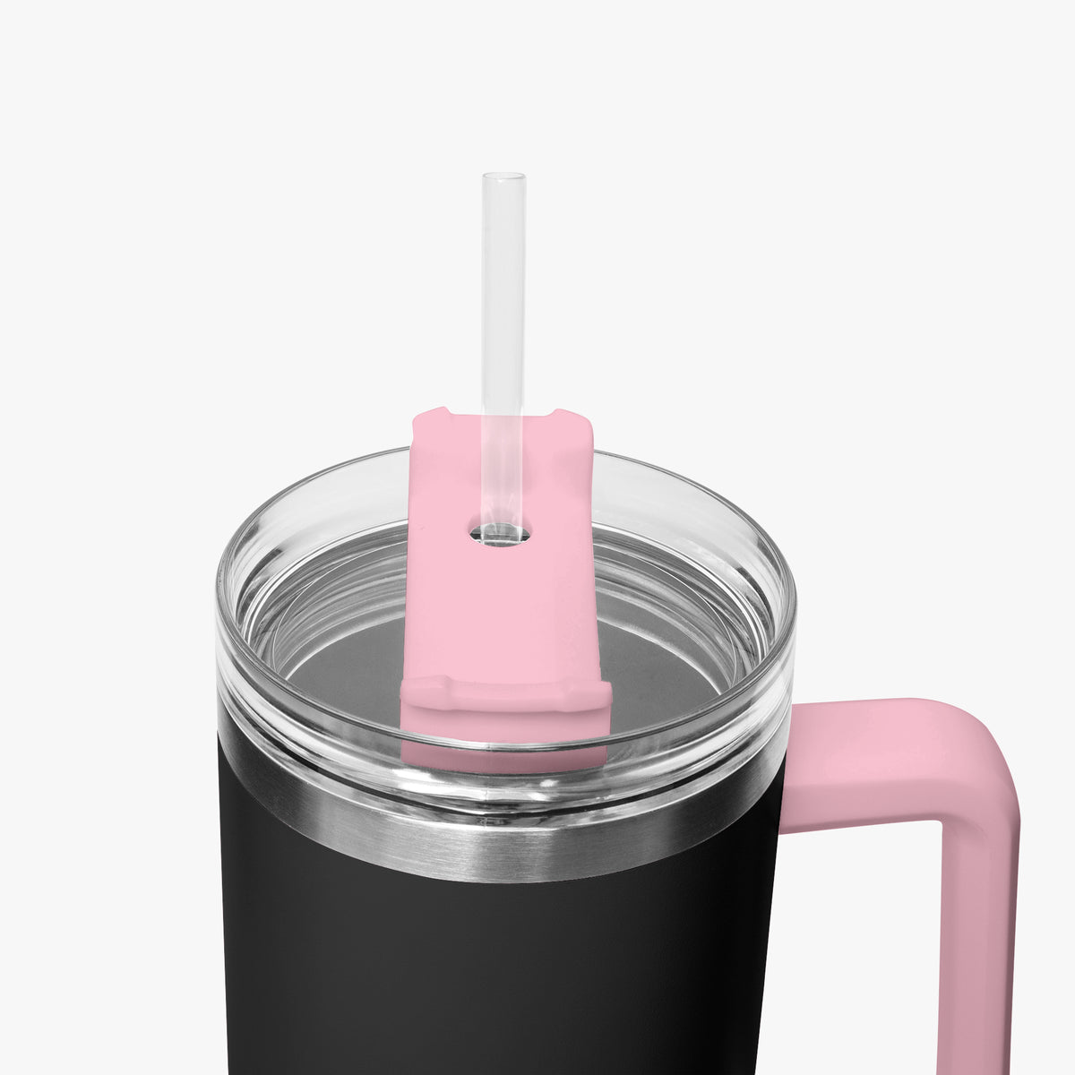 Close-up of a black insulated tumbler with a clear lid, pink straw cover, and pink handle on a light gray background.