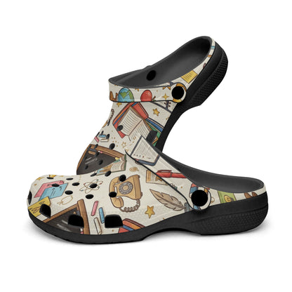 Kids teacher clogs with teacher-themed print, black heel, and round ventilation holes.
