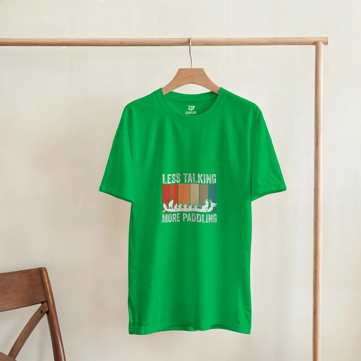 Unisex green t-shirt on hanger with LESS TALKING MORE PADDLING dragon boat print